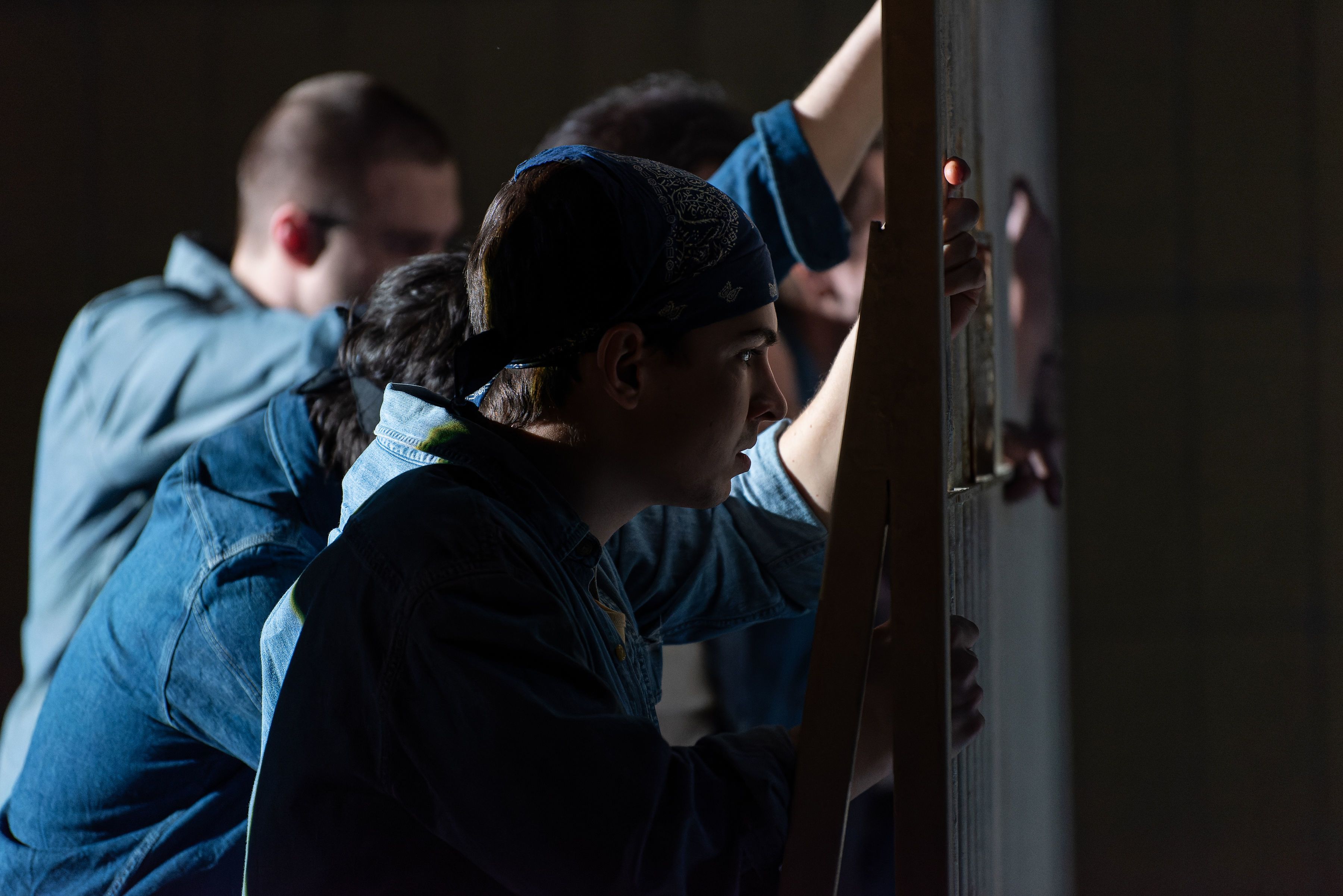 Prisoners standing behind the bars